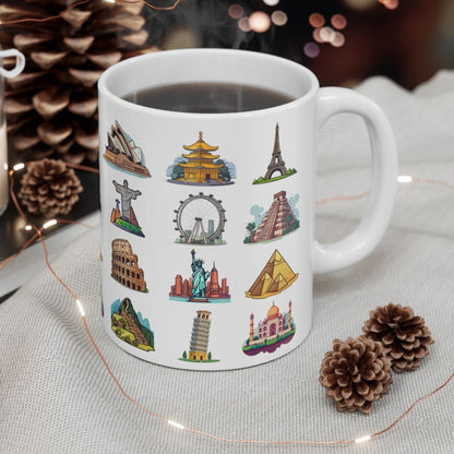White ceramic coffee mug featuring famous world travel landmarks, placed on a table draped in a white cloth, amidst the warm glow of decorative lights and other adornments