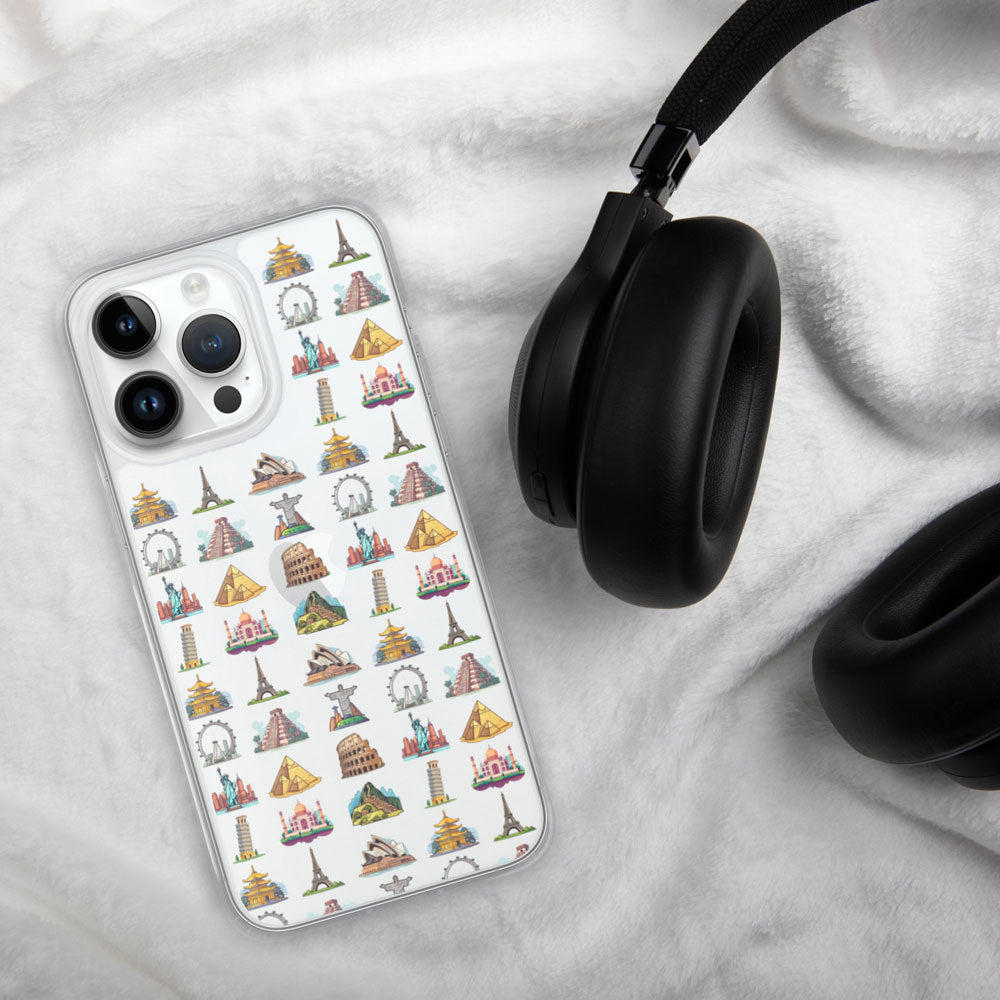 iPhone with a case featuring famous travel landmarks on a white linen background with a black headphone