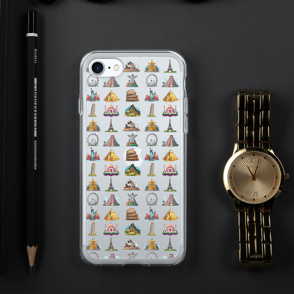 iPhone with a case featuring famous travel landmarks on a black background next to a gold watch and black pencil
