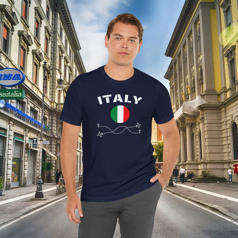 White man wearing a navy cotton T-shirt featuring the word 'Italy' and its rounded flag, in an European city background