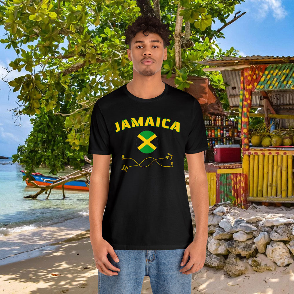 African man wearing a black cotton T-shirt featuring the word 'Jamaica' and its rounded flag, in a tropical beach background