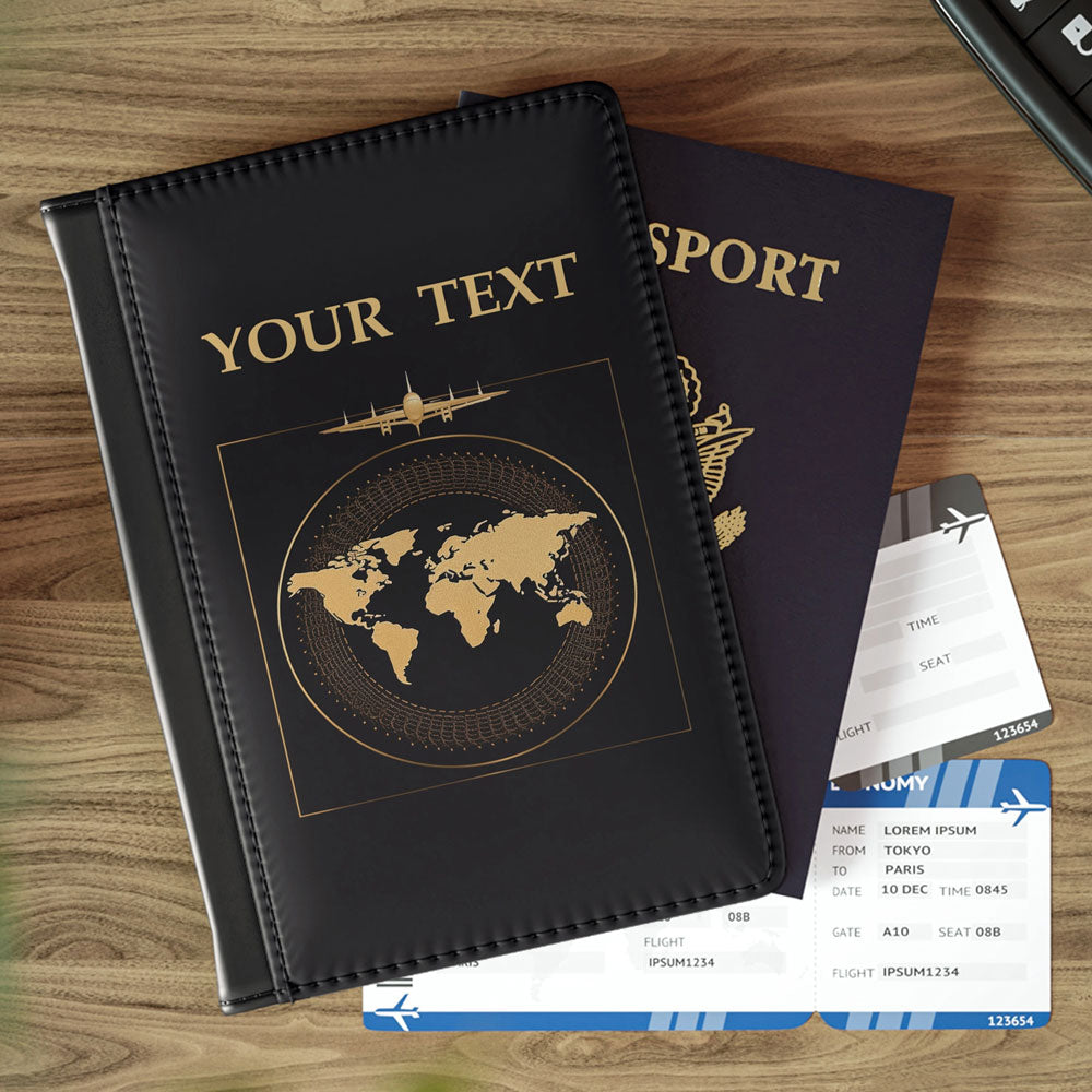 Black leather passport cover with custom world map design, resting on a wooden table with passport and boarding passes