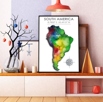 Black-framed colorful South America map poster against a pink and purple background with decorative elements
